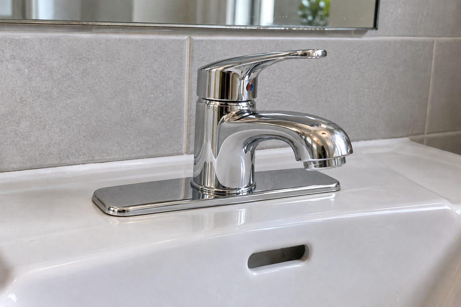 After: a clean chrome mixer tap fitted to the bathroom sink